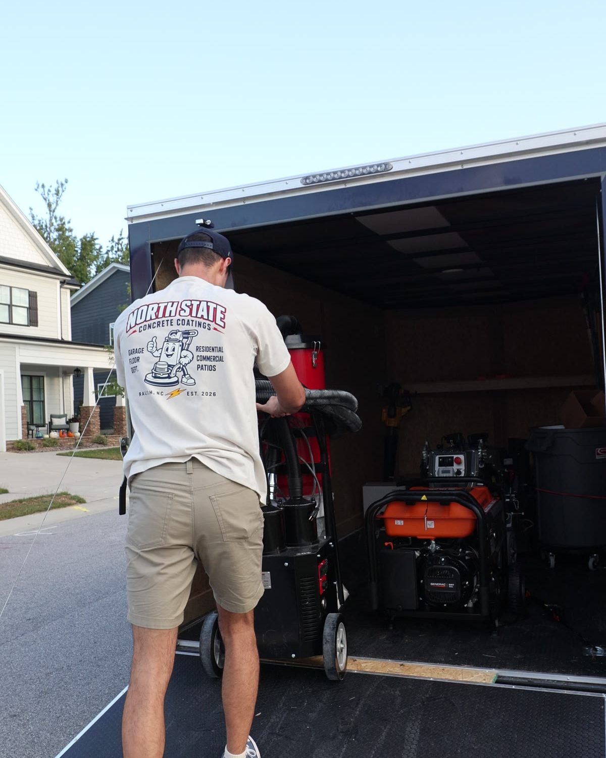 Nick unloading the grinder from the North State Coatings trailer at a job